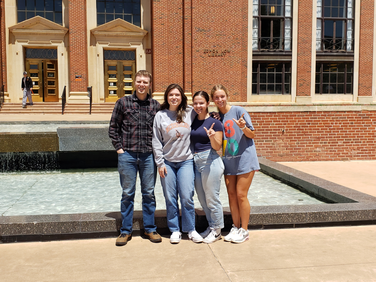 Reed, Claire, Reagan, and Addison in front of Edmon Low Library on the Stillwater Campus